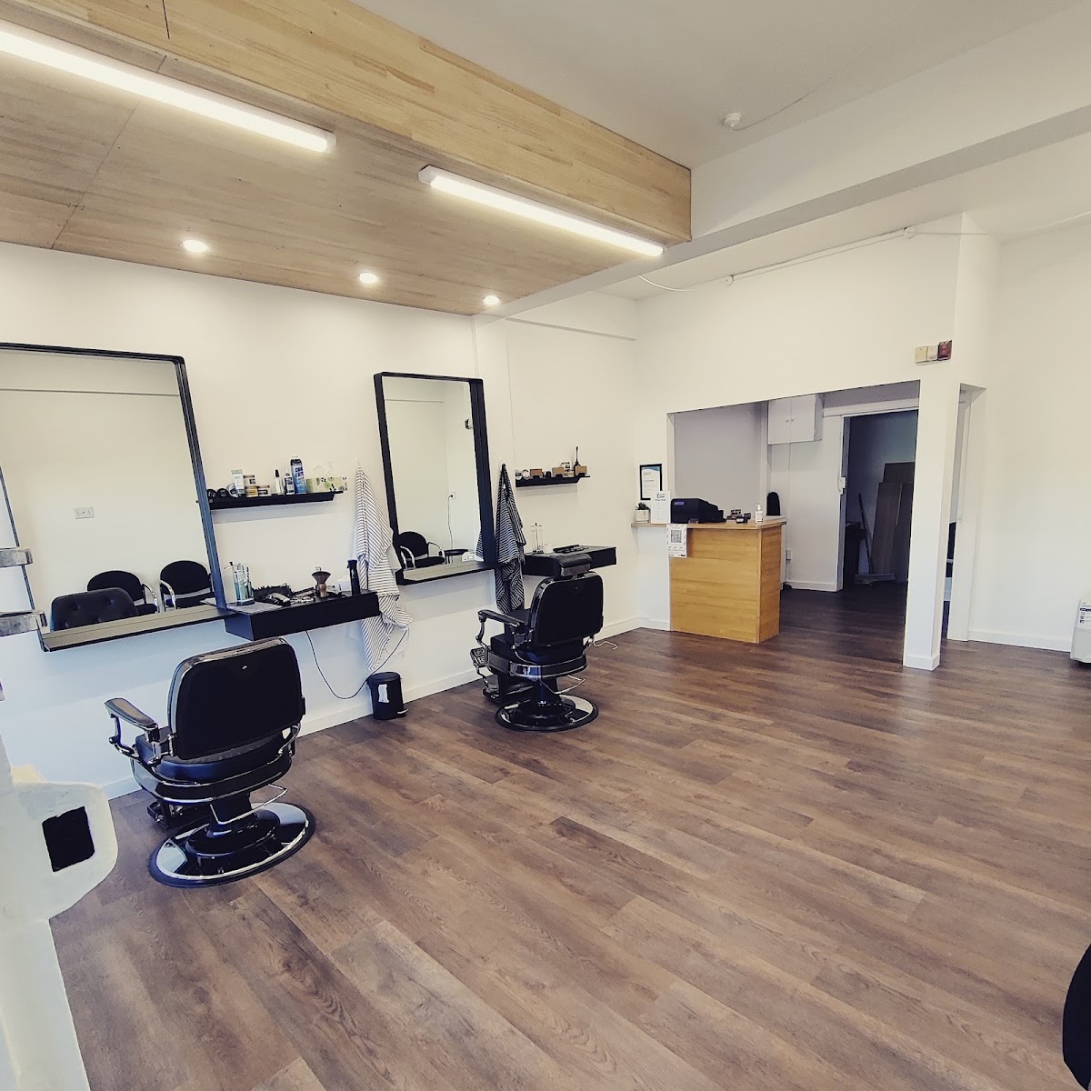 Inside No Good Barbers: vintage black barber chairs, big mirrors and timber ceiling