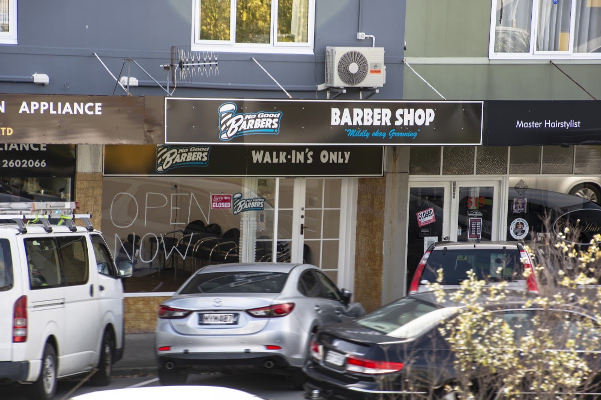 The No Good Barbers shopfront on High Street with the Mildly okay Grooming sign